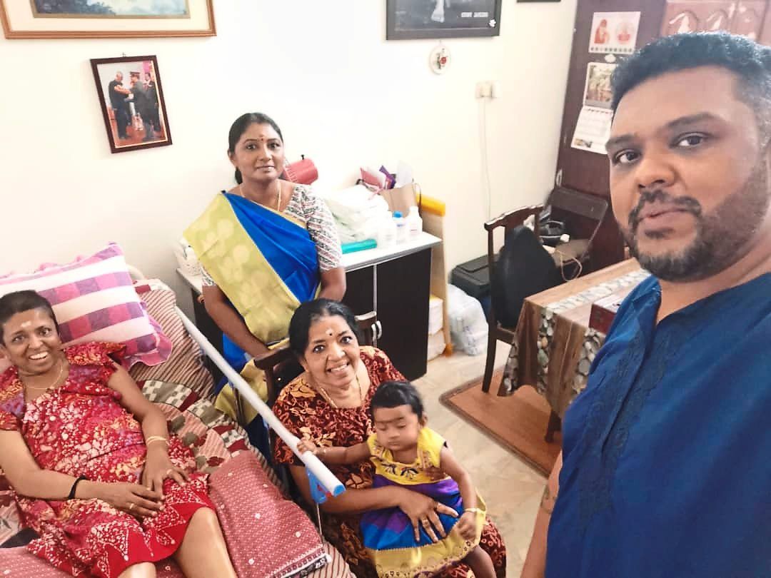 Family support is extremely important and Vali (left) considers her brother Ananthagopi (right) her rock as he doubles up as her main caregiver. Seen here with them are their mother who is seated with her granddaugher, and Ananthagopi’s wife (standing). 