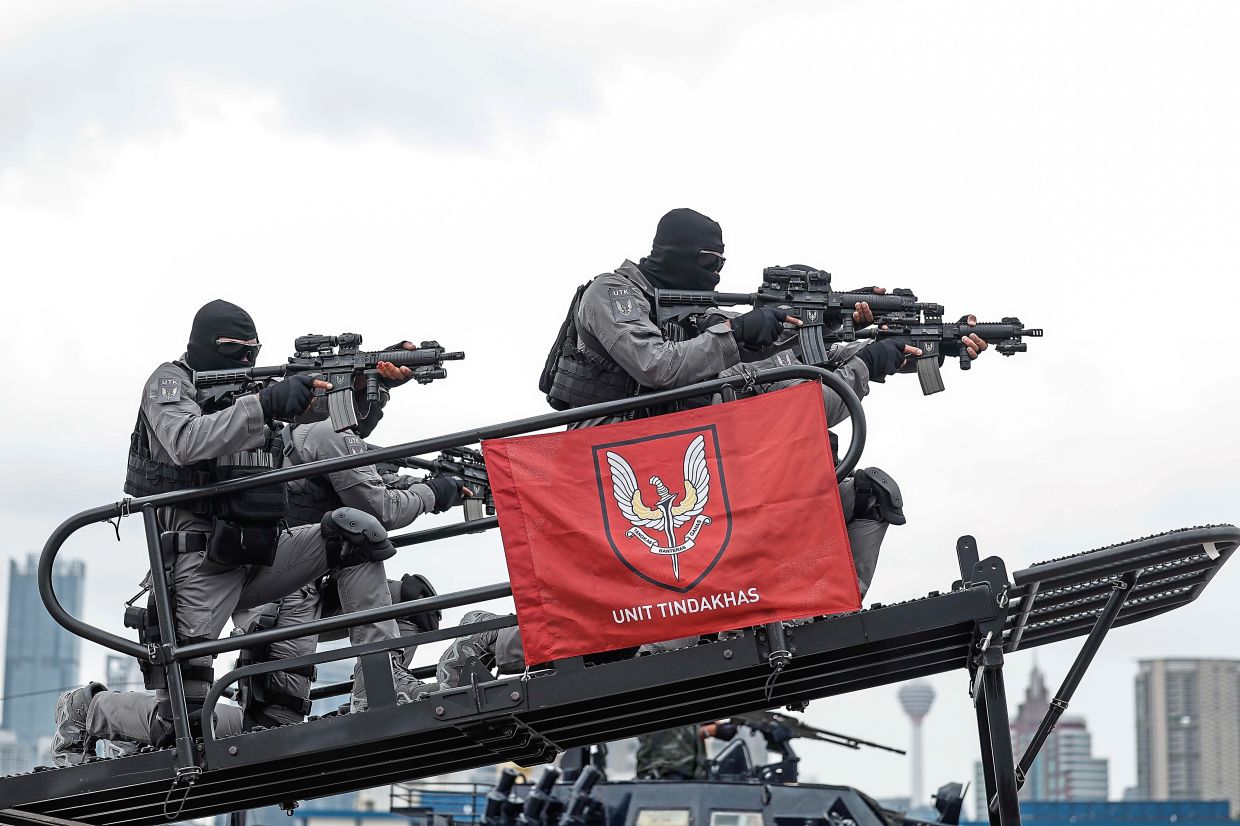 Oficers from the special task force of the Royal Malaysian Police participate in a march-past.