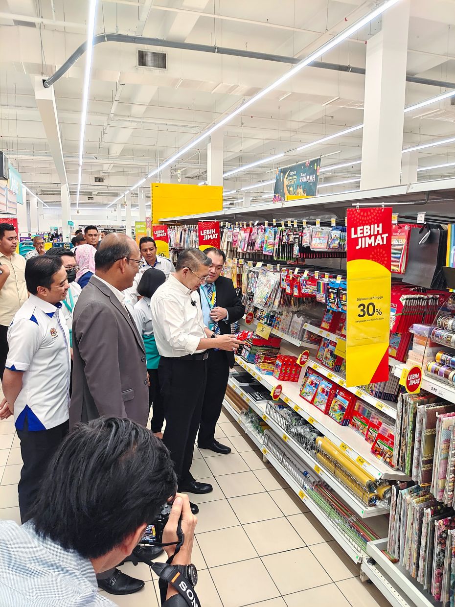 Salahuddin checking on the discounted price of stationery and other school essentials.