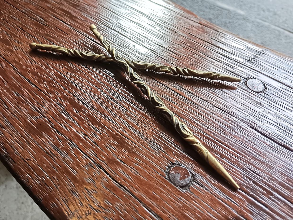 Brass hairpins that carry a motif of twisting vines. Photo: Jason Labunda