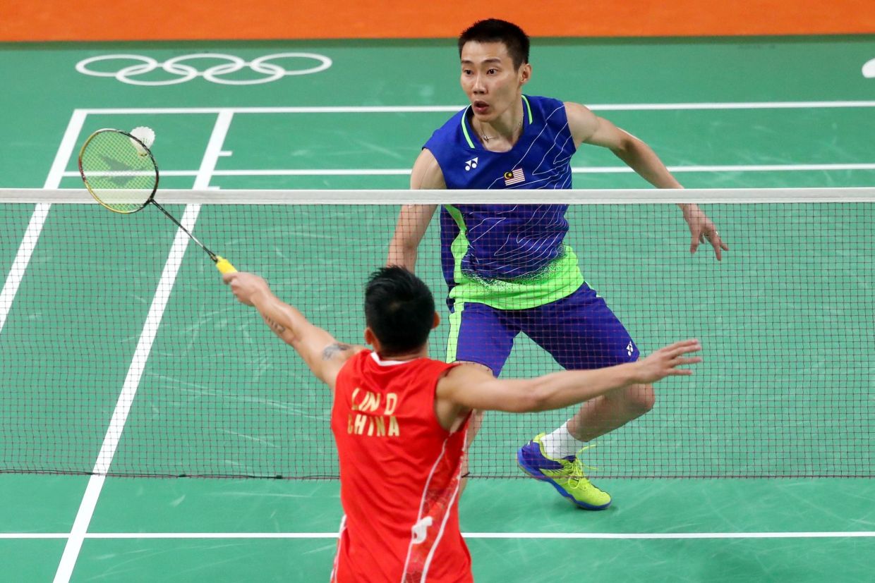 Watching his two favourite badminton players, Lee (facing camera) and Lin, during an exciting finals match proved too much for Chin one day, as he had a heart attack later that night. — Filepic