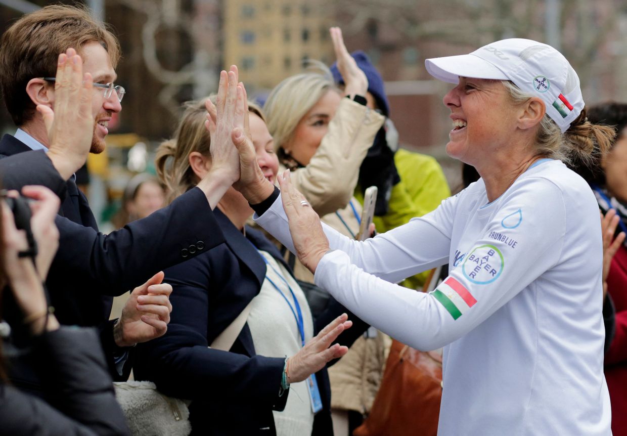 Guli greeting fans after completing her 200th marathon outside UN headquarters.