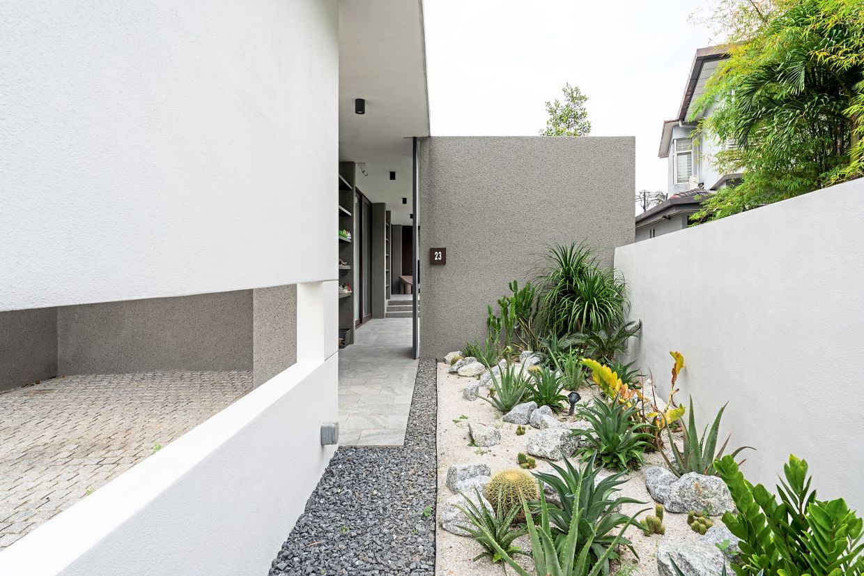 The minimalist, low-maintenance garden is filled with tropical dry plants such as cactus, palm and aloe vera.