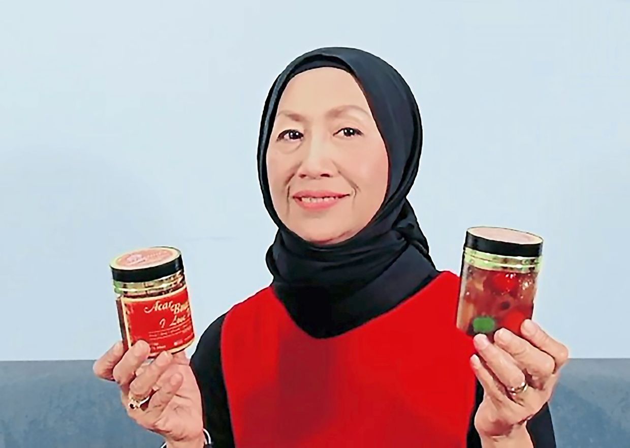 Martini with her pickled fruits product ‘Acar Buah I Love U’ which is available for sale online.