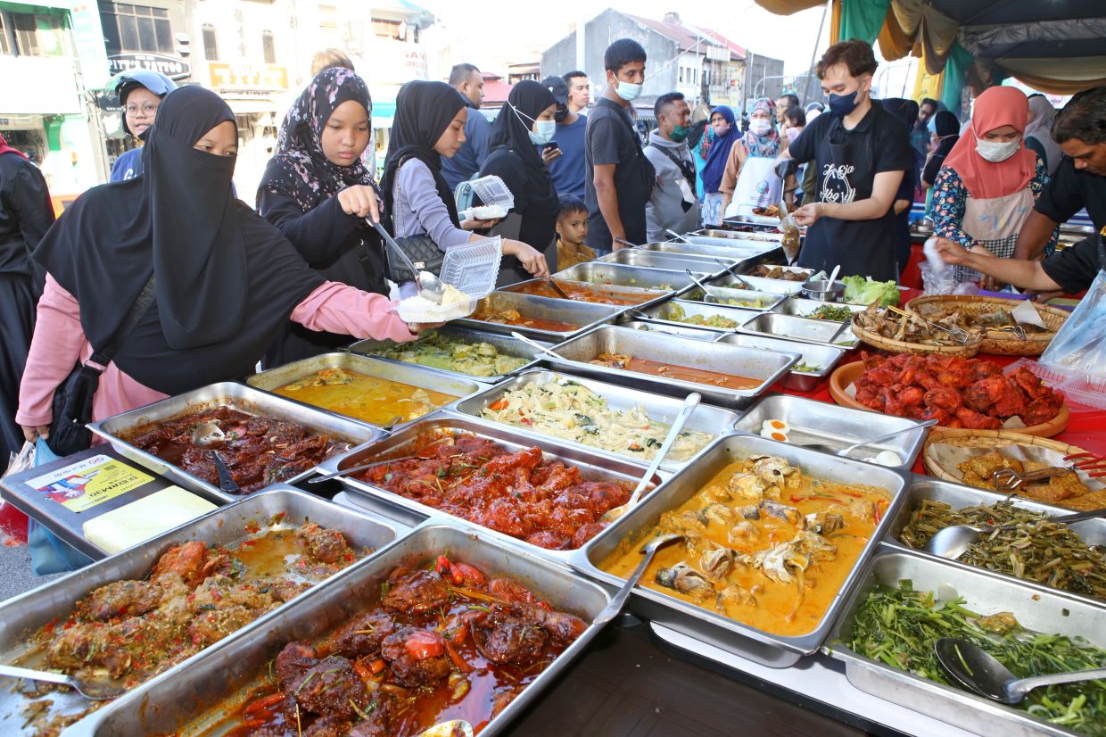 Keep track of your spending at food bazaars. Photo: The Star/Chan Boon Kai