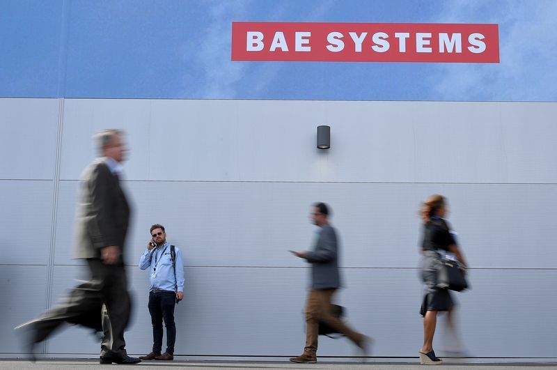 FILE PHOTO Trade visitors walk past an advertisement for BAE Systems at Farnborough International Airshow in Farnborough Britain July 17 2018. REUTERSToby Melville