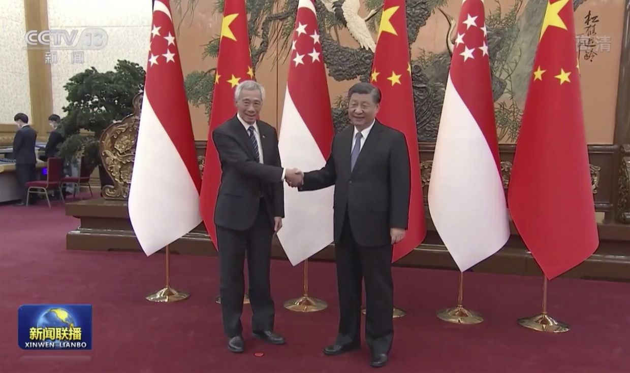 In this image taken from video footage run by China's CCTV, Singapore Prime Minister Lee Hsien Loong, left shakes hands with Chinese President Xi Jinping during a meeting at the Great Hall of the People in Beijing. - AP