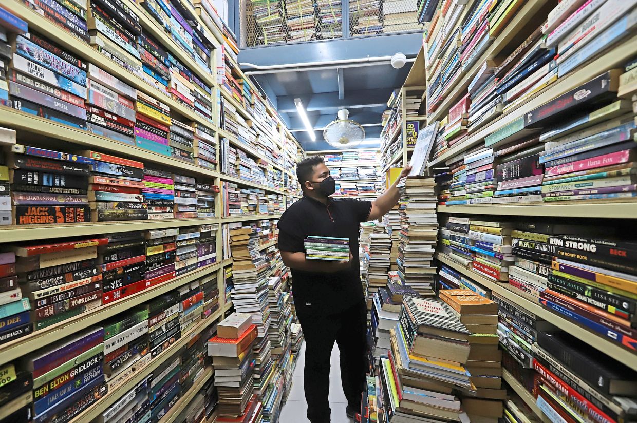 Young bookshop owner Sabri Sabran Naseer Khan seen at his secondhand bookstore, which he took over from his father, at Chowrasta Market.