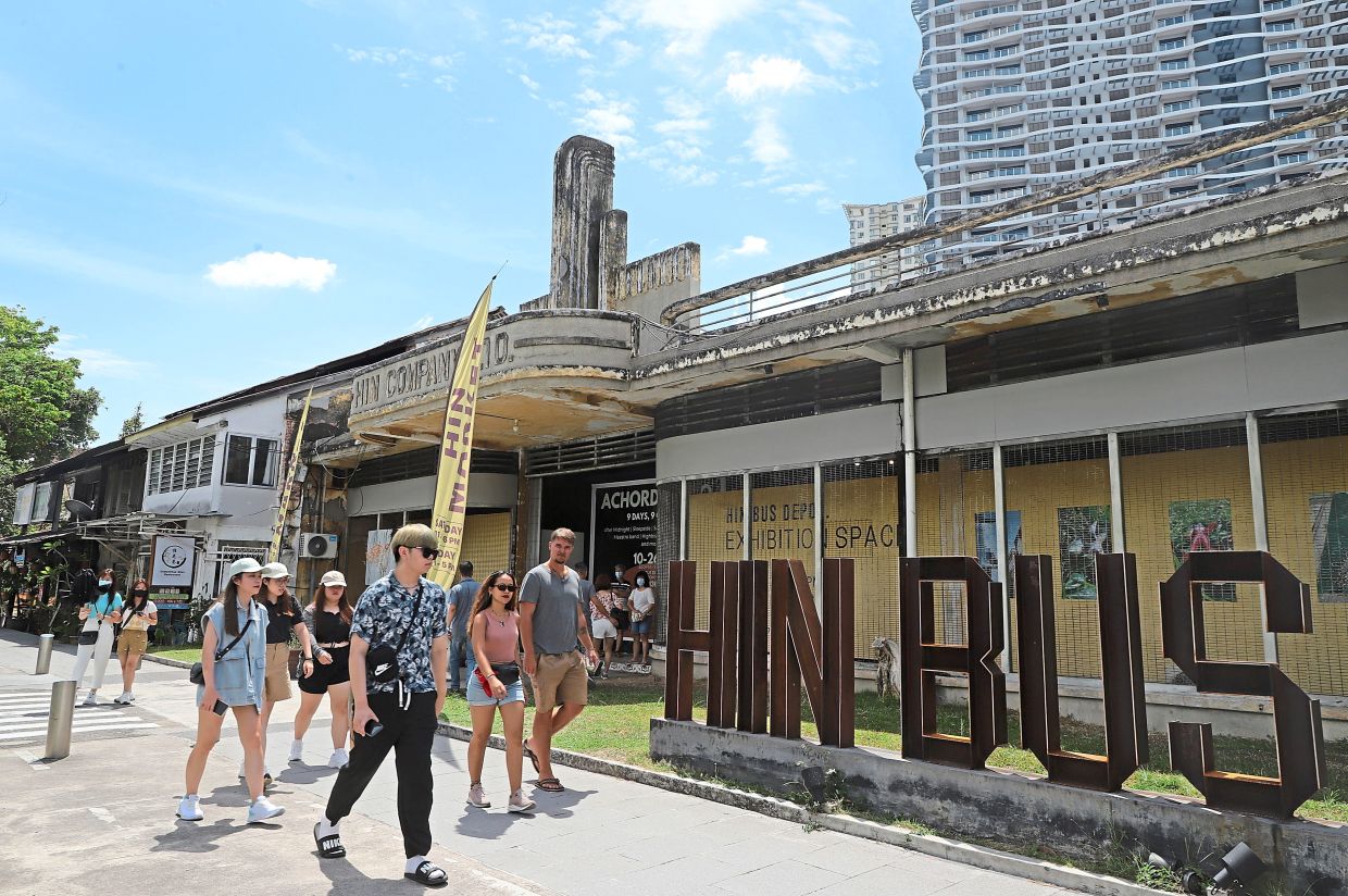 People strolling by the front of Hin Bus Depot along Jalan Gurdwara, which is today, one of George Town's most popular hubs for art, culture and all forms of creative endeavours.