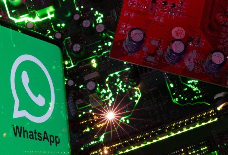 FILE PHOTO A smartphone with a displayed WhatsApp logo is placed on a computer motherboard in this illustration taken February 23 2023. REUTERSDado RuvicIllustration