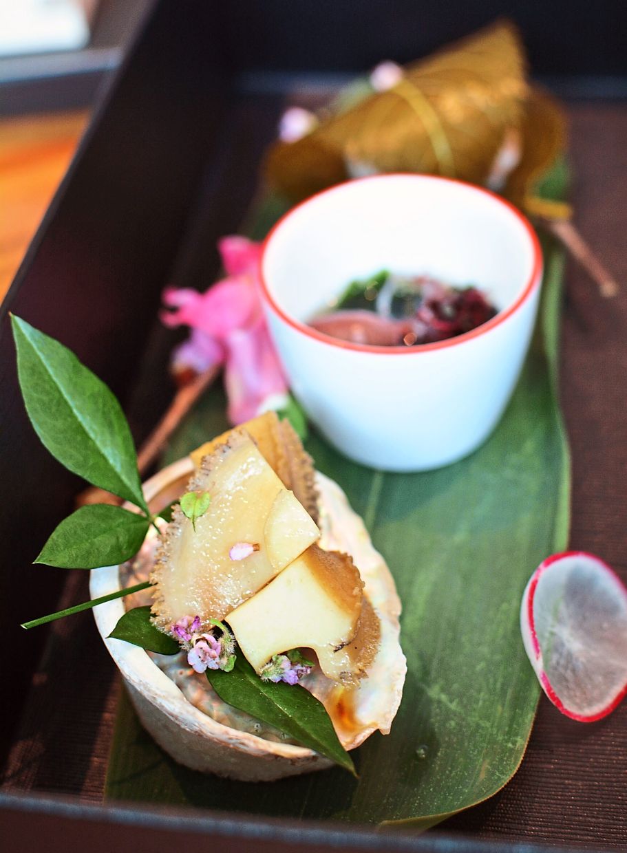 The cold dish set has sauteed abalone in butter soy, boiled Hotaru Ika and Wakame in umami broth and Madai Tamari sushi ball wrapped with sakura leaf.