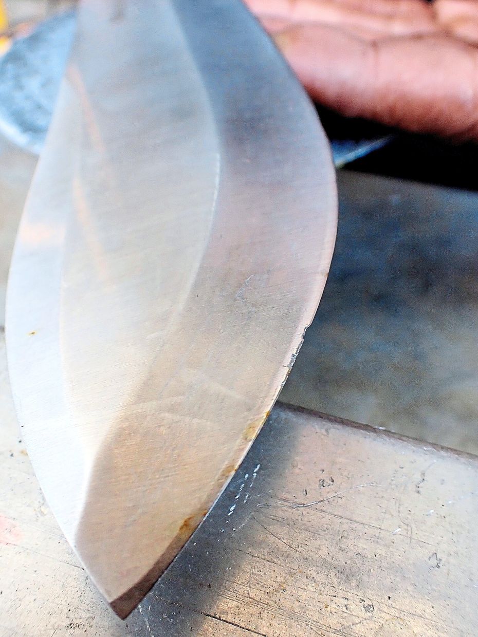 This Muela Machete long camping knife is badly chipped due to contact with stones during brush clearing work at camp;