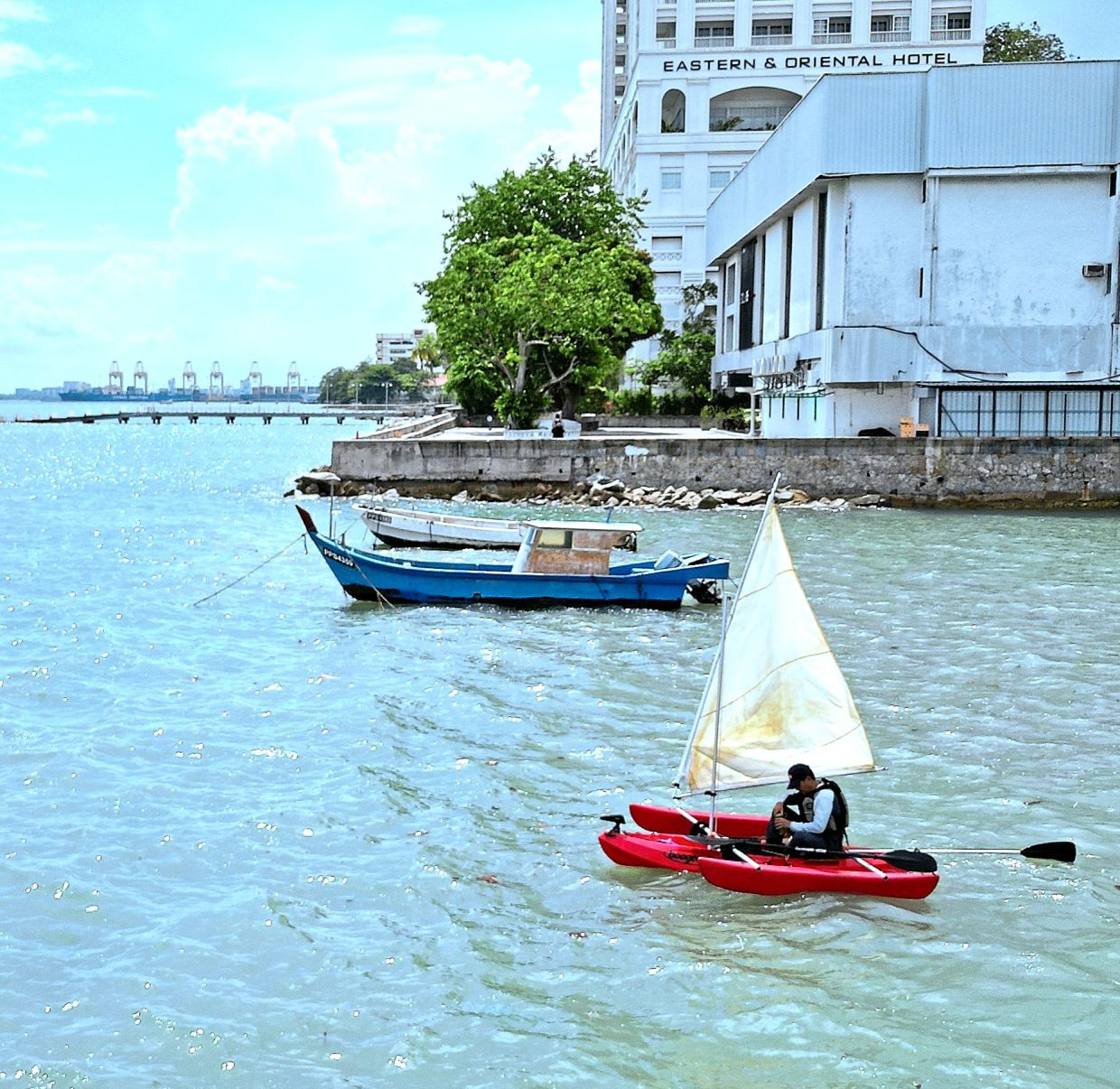 Khoo spending quality time on his custom-built trimaran sailing kayak in the George Town bay area near Eastern and Oriental Hotel.