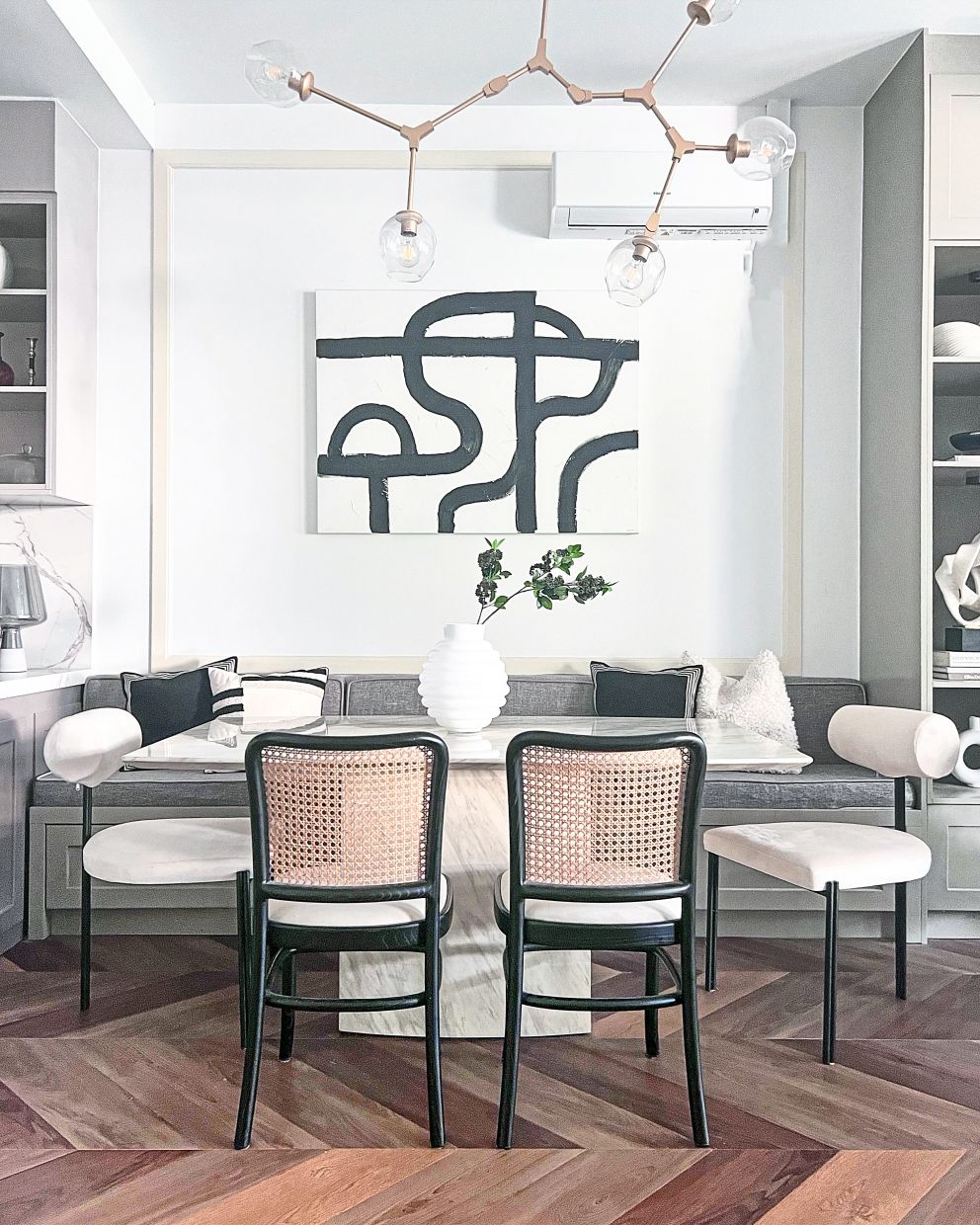 The black-and-white painting by Ain and her husband hangs proudly in the dining area.