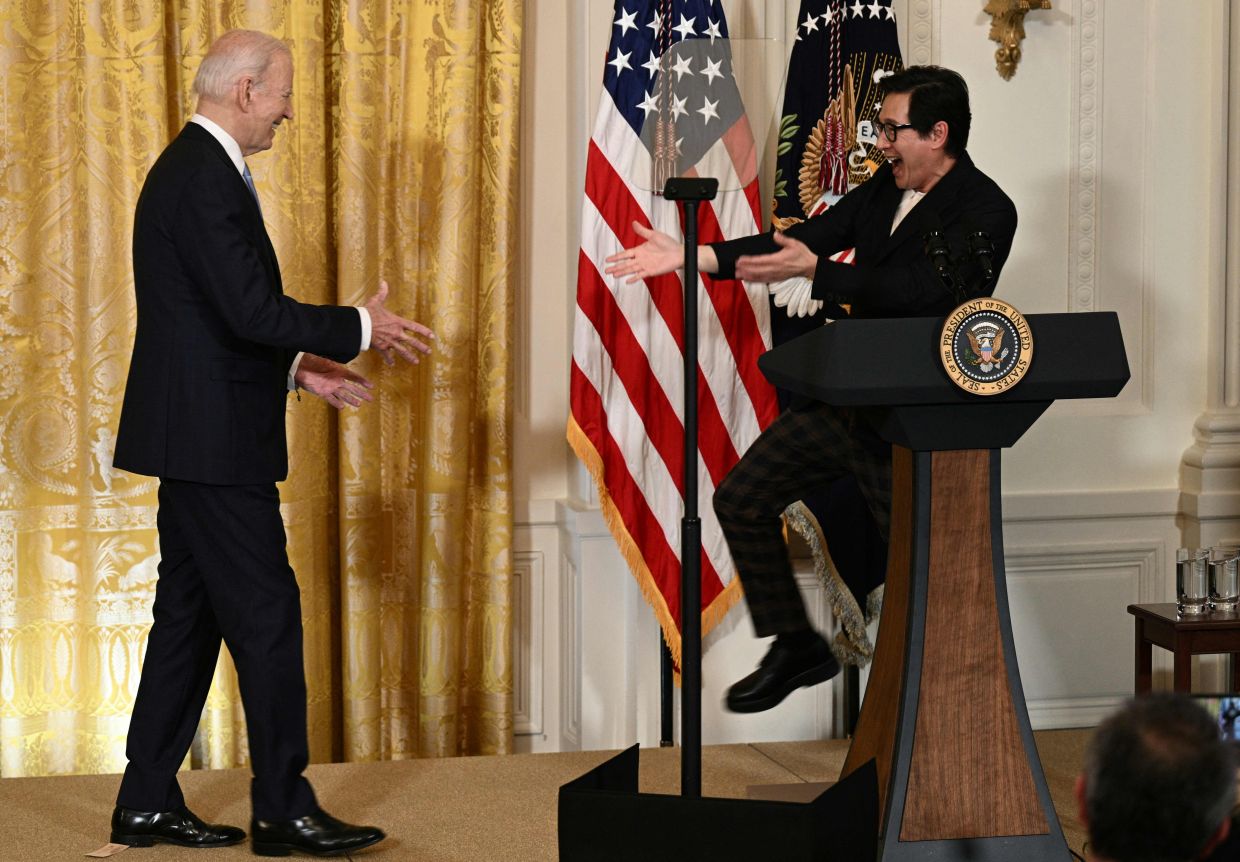 Ke Huy Quan reacts to US President Joe Biden before a screening of 'American Born Chinese' in celebration of Asian American, Native Hawaiian, and Pacific Islander Heritage Month, in the East Room of the White House in Washington, DC, on May 8, 2023. Photo: AFP