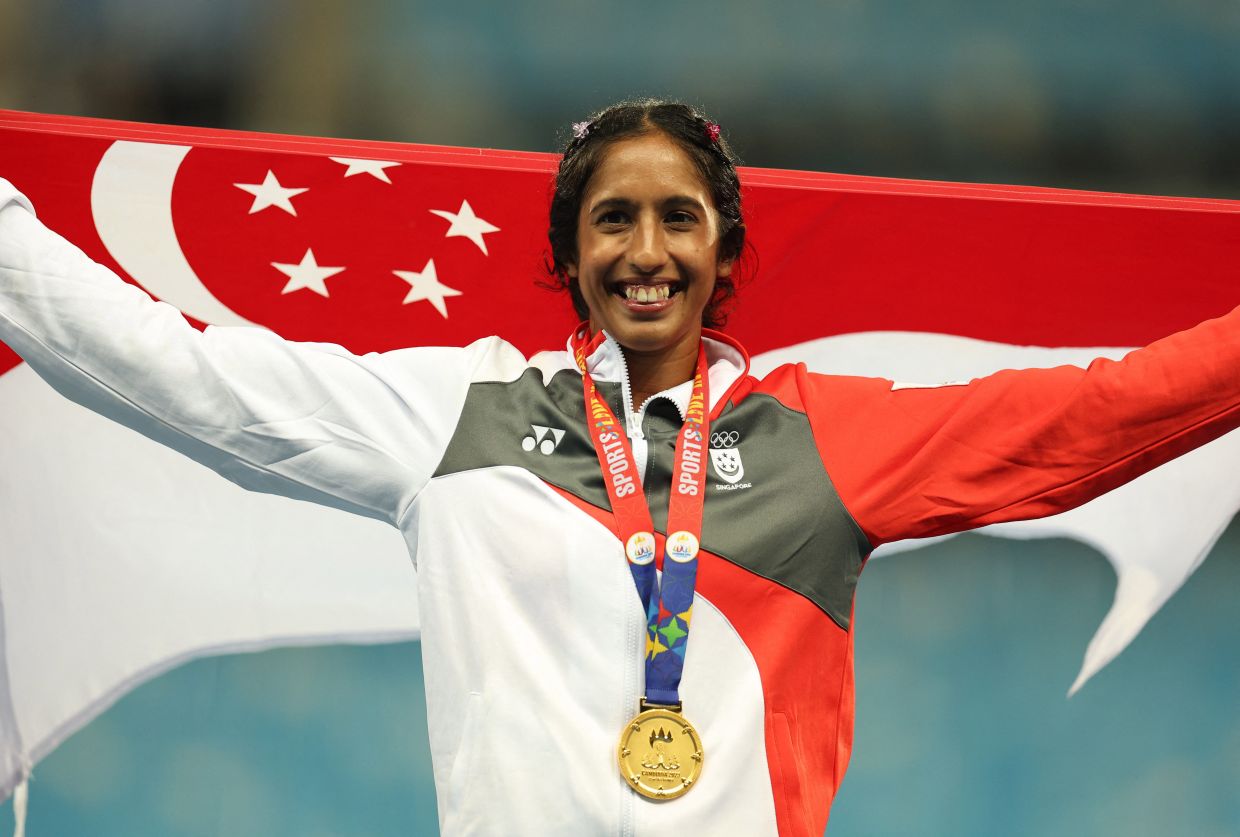 Women's 100m final gold medallist Singapore's Veronica Shanti Pereira celebrates after winning the main athletics event at the Asean Games in the Morodok Techo National Stadium, Phnom Penh, Cambodia, on Friday, May 12, 2023. - AFP