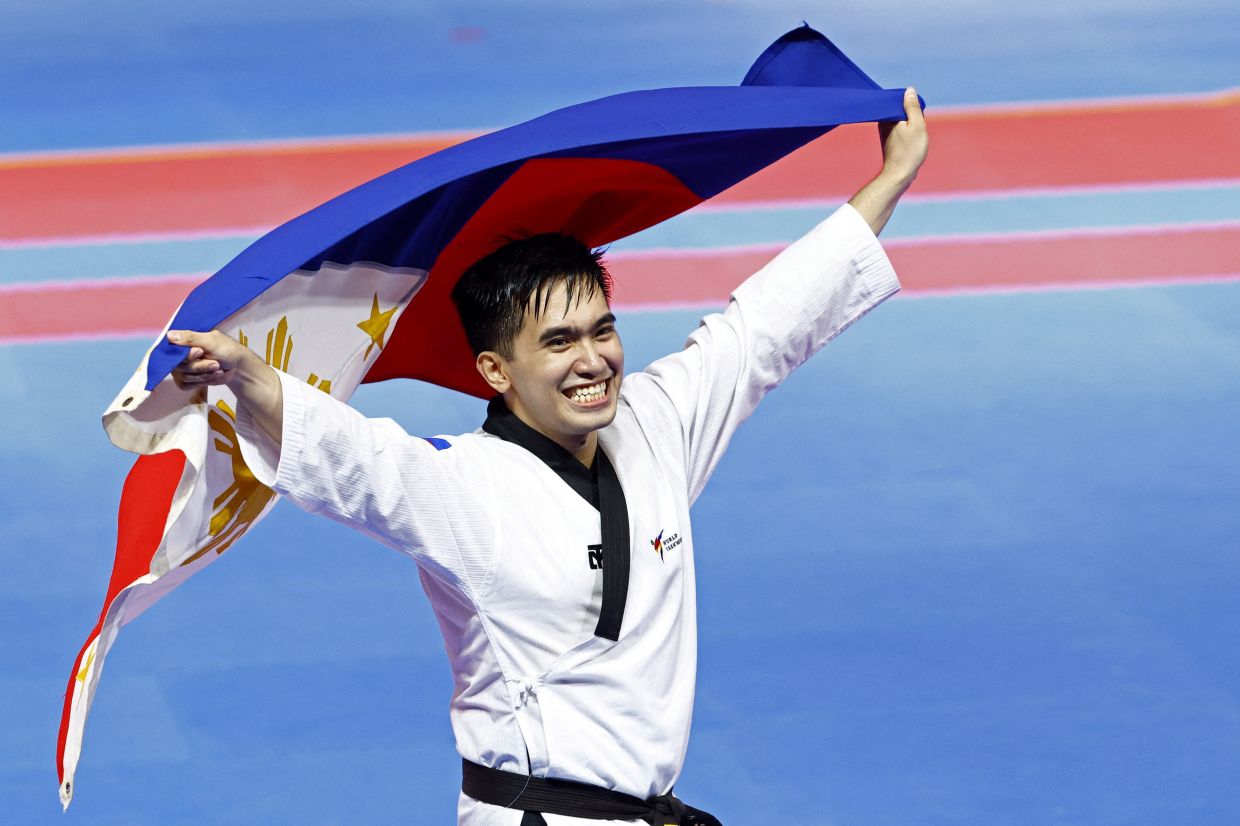 Philippines' Patrick King Dela Cruz Perez reacts after winning gold in the men's Taekwondo's Recognized Poomsae individual final at the ASEAN Games in Chroy Changvar Convention Centre Hall F, Phnom Penh, Cambodia, on Friday, May 12, 2023. - Reuters