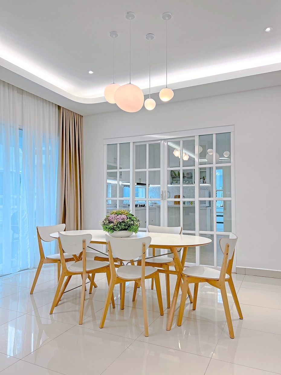 The dining area in Madsmona’s home has a simple, cosy feel, with the signature piece being the overhead designer lights.