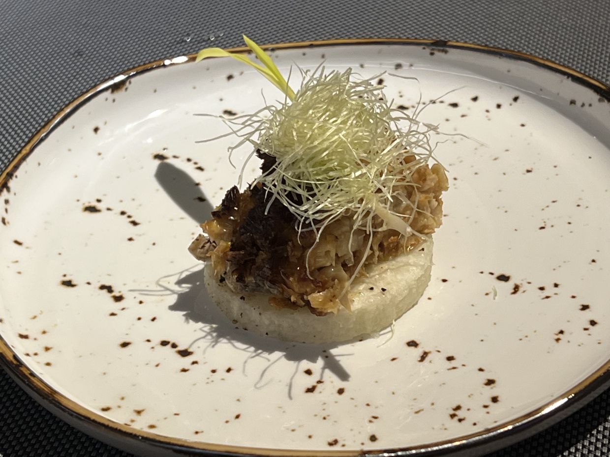 Bamboo-cooked white corn with caraway burnt butter and jicama.