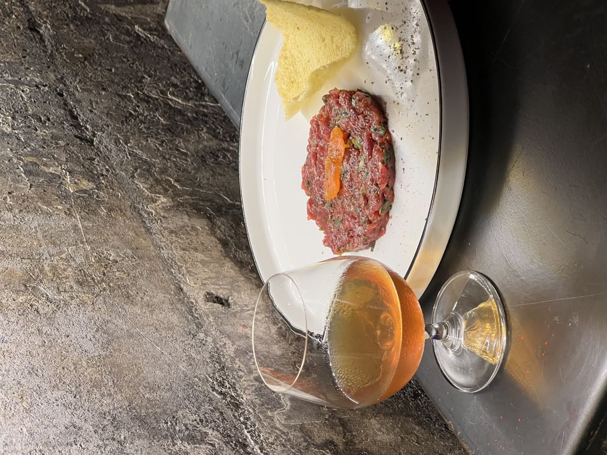 Local beef tenderloin tartare, paired with a drink made with japanese whisky, mushroom rojo vermouth and sweet malt tea syrup.