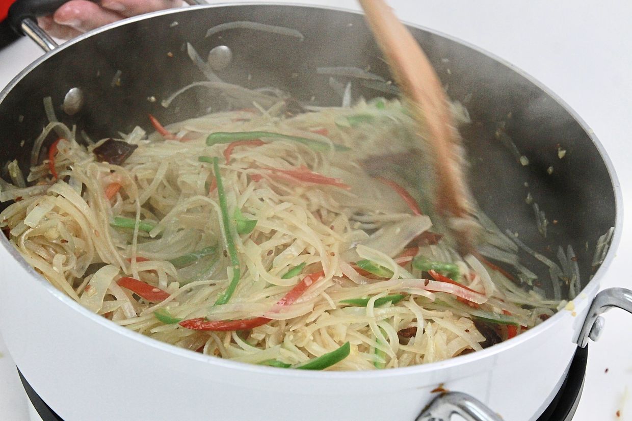 Add the seasoning and toss to coat the potatoes in the sauce, taking care not to overcook.