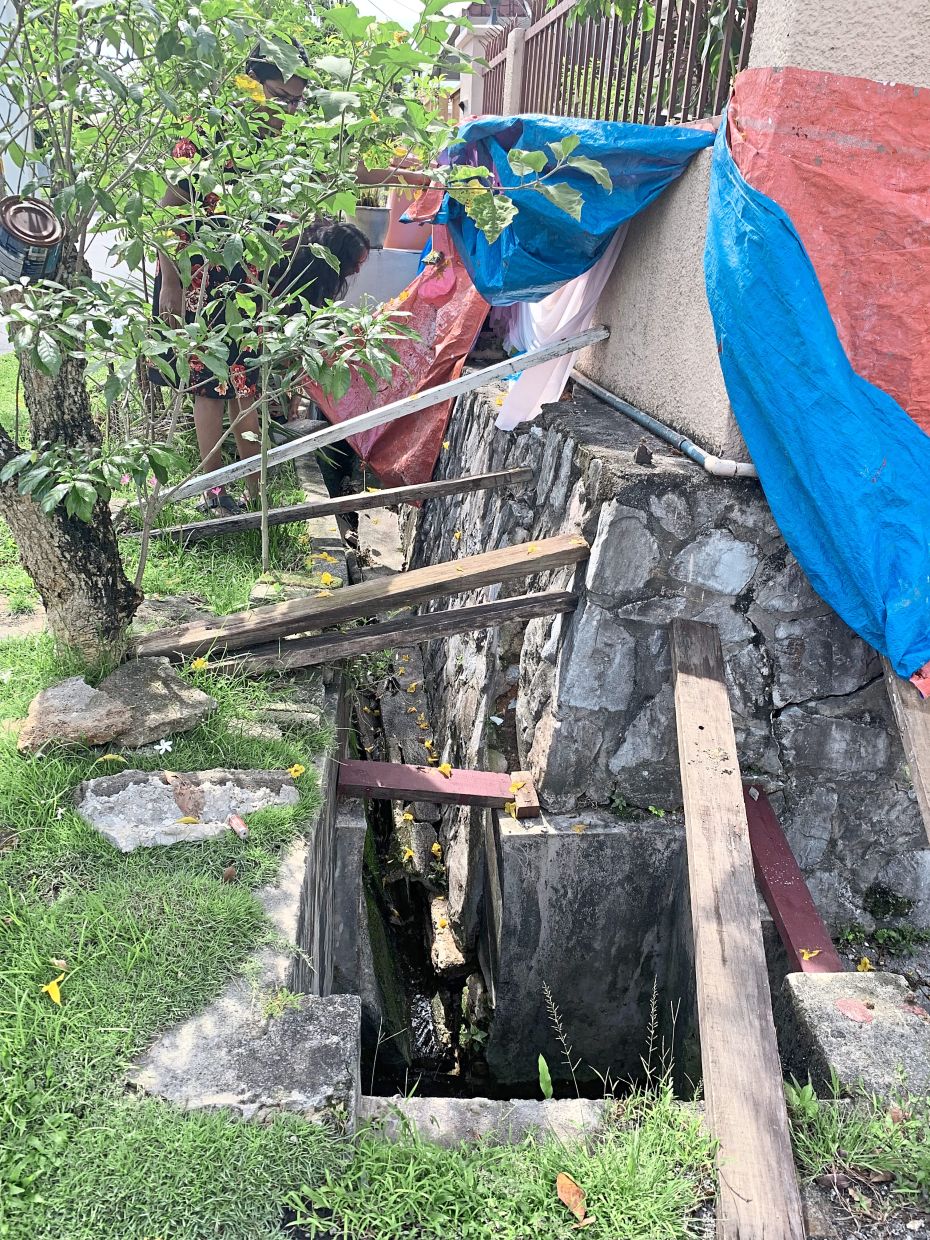 Wooden planks being used to prevent the concrete wall from collapsing.