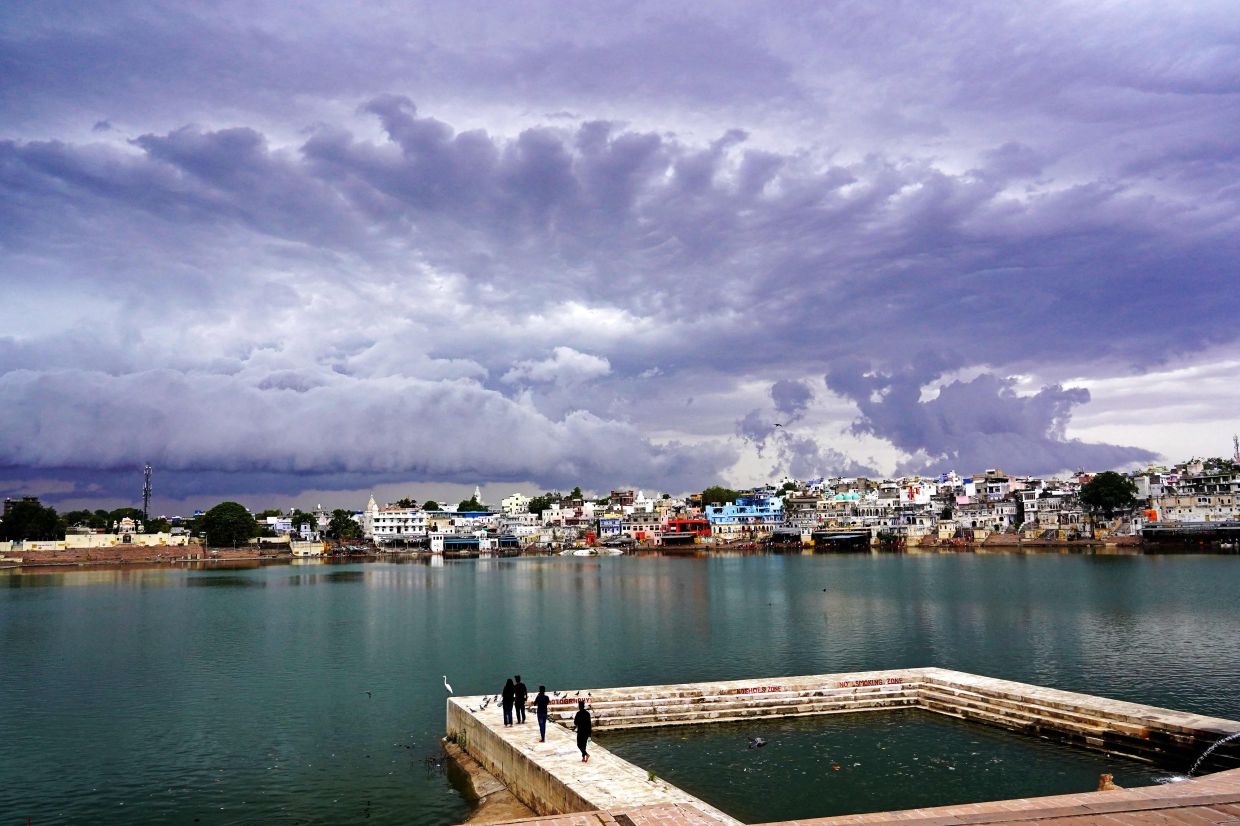 Rain clouds hover over the holy lake Of Pushkar in India's desert state of Rajasthan on Tuesday, May 30, 2023. - AFP