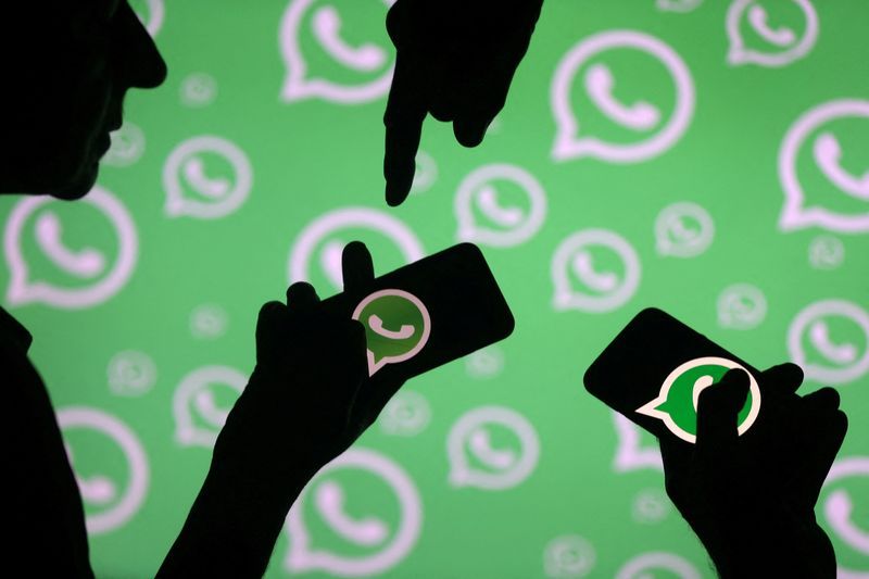 FILE PHOTO Men pose with smartphones in front of displayed Whatsapp logo in this illustration September 14 2017. REUTERSDado RuvicFile Photo