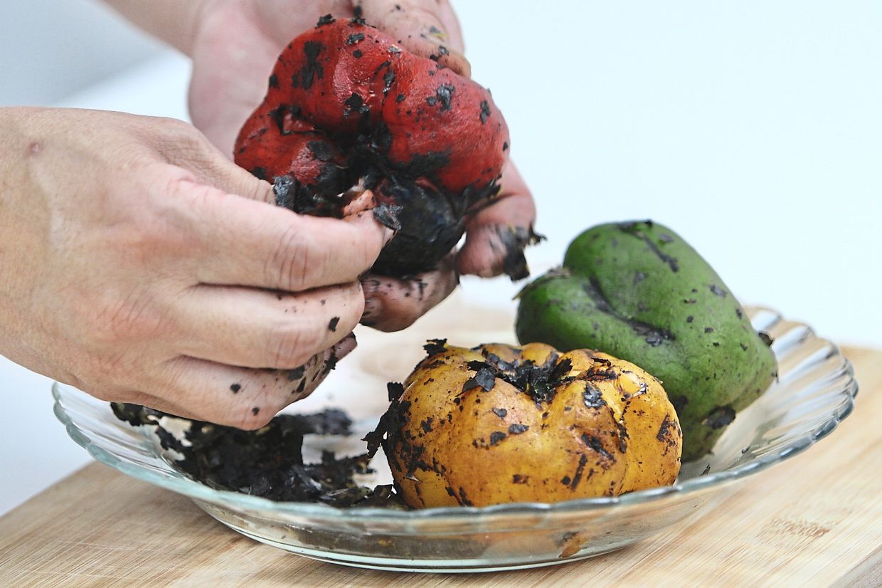 Scrape off the blackened skins and slice the roasted peppers into thin strips.