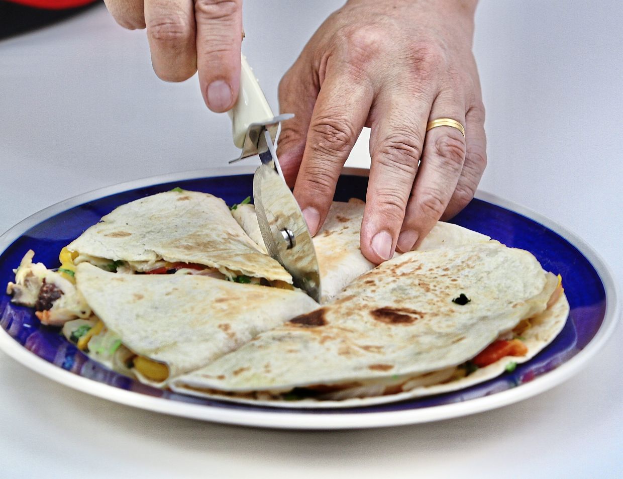 Cut into wedges and serve the quesadilla on its own or with a side of salsa, pico de gallo, quacamole and extra sour cream, if desired.