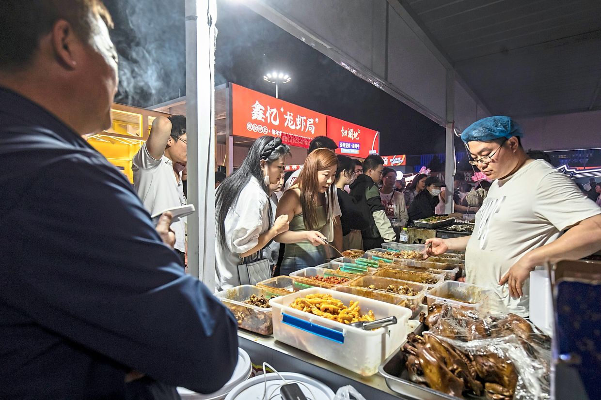 Diners picking the food they want grilled at a barbecue place in Zibo, China. — The New York Times