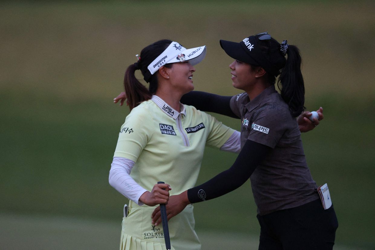 Ko Jin Young of South Korea (left) hugs Patty Tavatanakit of Thailand (R) on the ninth green during the second round of the Mizuho Americas Open at Liberty National Golf Club in Jersey City, New Jersey. - AFP