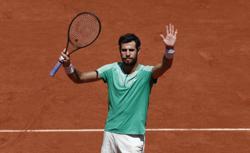 Tennis-Khachanov digs deep to reach French Open last eight