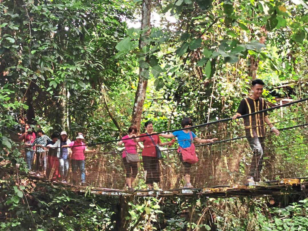 The writer and her group crossing the hanging bridge at the village.