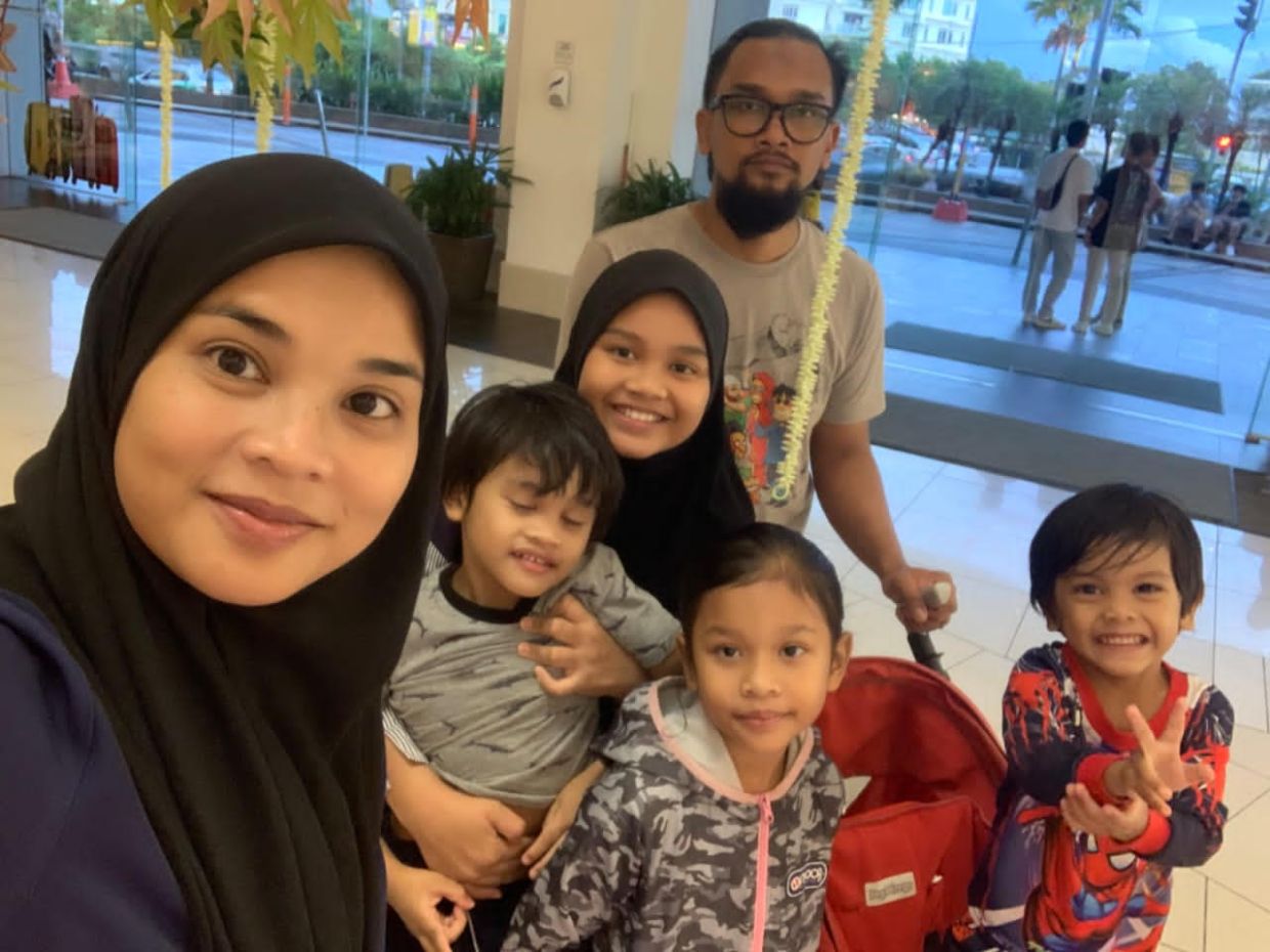 Farhana Hazwanee (with husband Mohd Faris Ismail and their children) says good hydration and ventilation are keys to managing hot weather. — FARHANA HAZWANEE HAMDAN