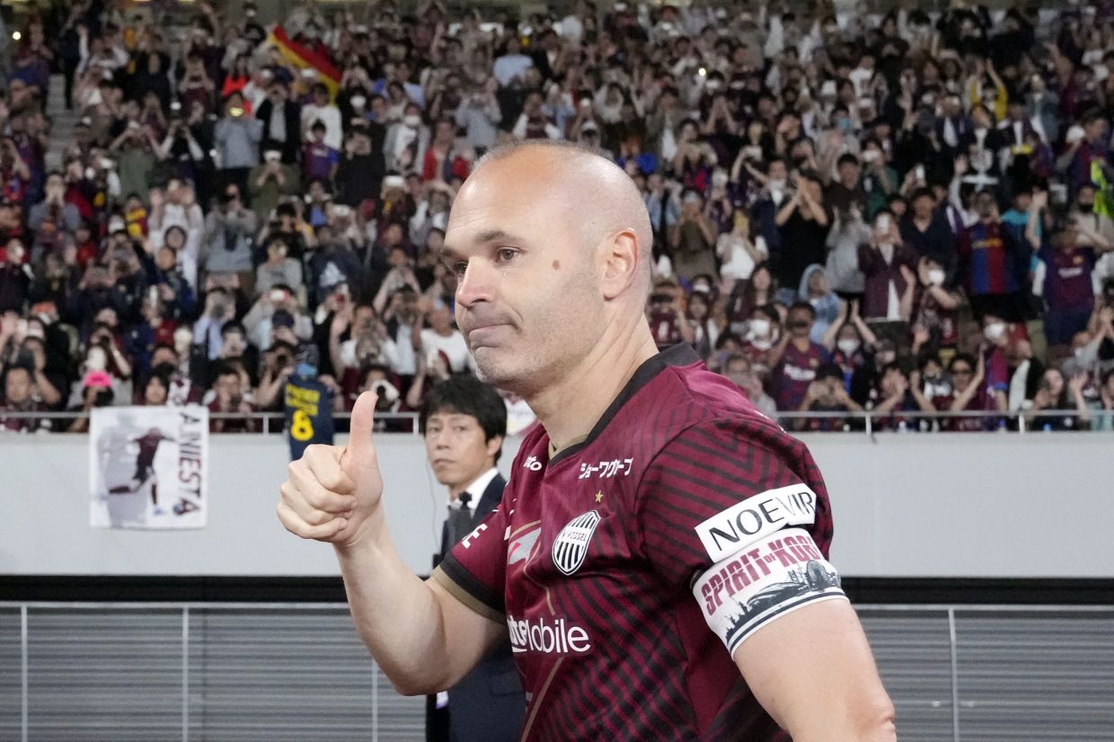 Vissel Kobe's Andres Iniesta greets the spectators after a friendly soccer match between his Japanese club Vissel Kobe and his old club Barcelona at the National Stadium in Tokyo, Tuesday, June 6, 2023.Barcelona won 2-0. - AP