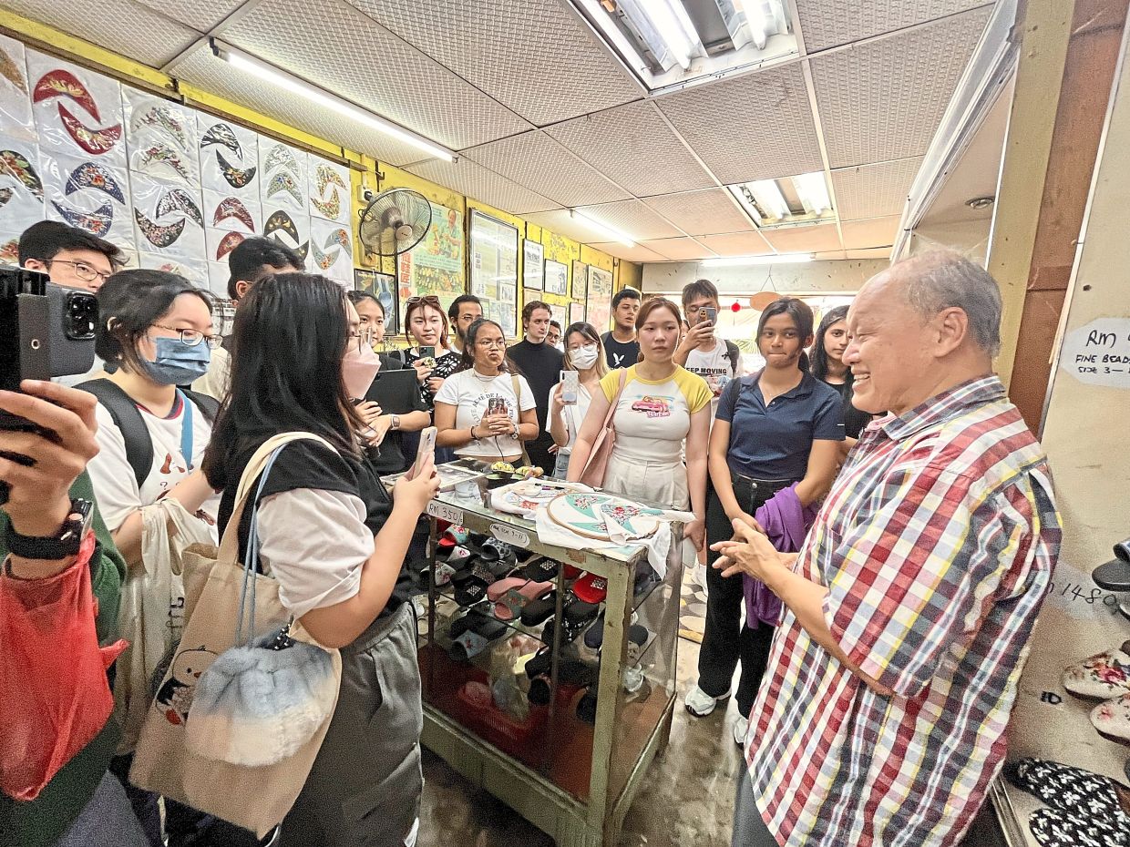 Lim Tiang Seng (right) of T.S. Lim Trading will sharing his stories about the art of kasut manek in the 'Heritage Trades Of Melaka' exhibition. Photo: The Bendahari