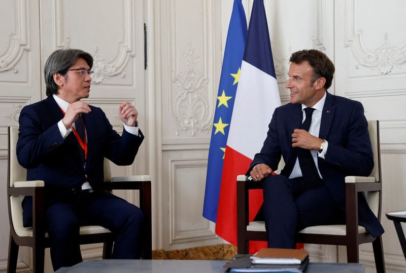 FILE PHOTO Frances President Emmanuel Macron speaks with ProLogiums CEO Vincent Yang during a meeting as part of the 5th edition of the quotChoose Francequot Business Summit at the Palace of Versailles southwest of Paris France July 11 2022. Ludovic MarinPool via REUTERS