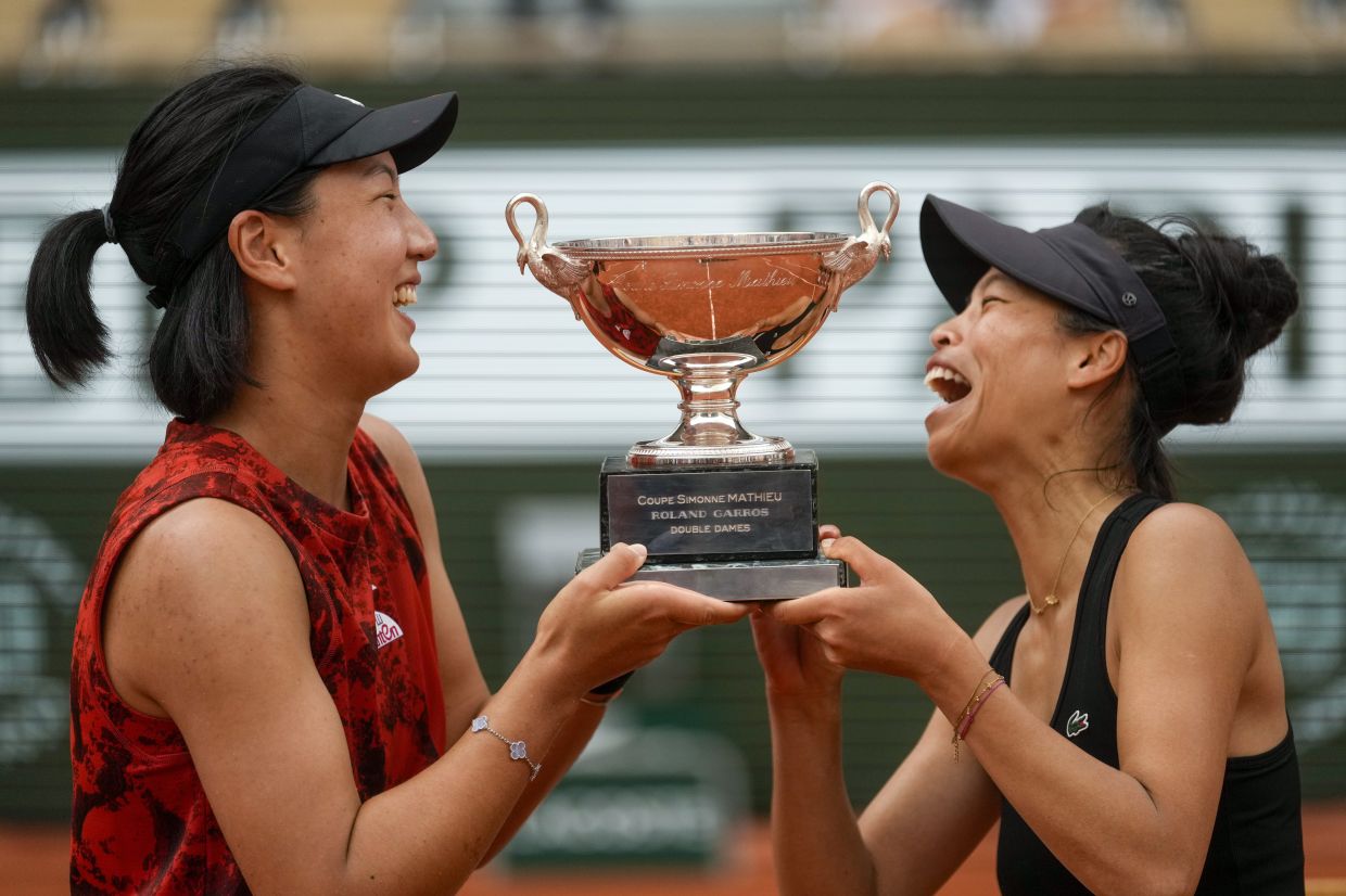 China's Wang Xinyu (left) and Hsieh Su-Wei of Taiwan lift the trophy as they celebrate winning the women's doubles final match of the French Open tennis against Canada's Leylah Fernandez and Taylor Townsend of the US at the Roland Garros stadium in Paris, Sunday, June 11, 2023. - AP