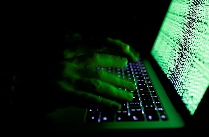 FILE PHOTO A man types on a computer keyboard in front of the displayed cyber code in this illustration picture taken on March 1 2017.REUTERSKacper PempelIllustration