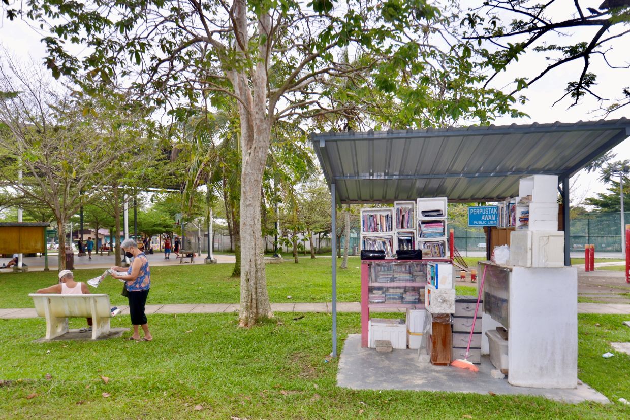 Park visitors can get something to read from the outdoor library while relaxing amid the peaceful surroundings at Taman Wawasan in Puchong, Selangor. RAJA FAISAL HISHAN/The Star