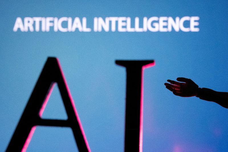 FILE PHOTO AI Artificial Intelligence letters and robot hand miniature in this illustration taken June 23 2023. REUTERSDado RuvicIllustration