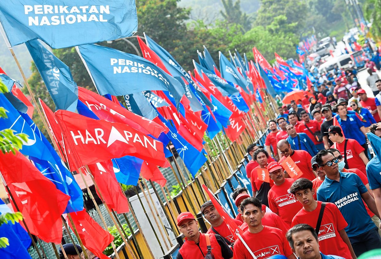 Confident bid: Pakatan and Perikatan supporters heading to the nomination centre in Gombak, Dewan SMK Sungai Pusu, on nomination day yesterday. — AZHAR MAHFOF/The Star