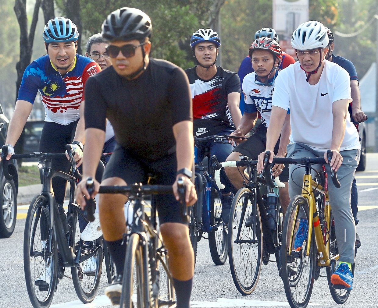Campaign trail: Azmin (right) cycling with his supporters in Taman Melawati, Kuala Lumpur. — FAIHAN GHANI/The Star