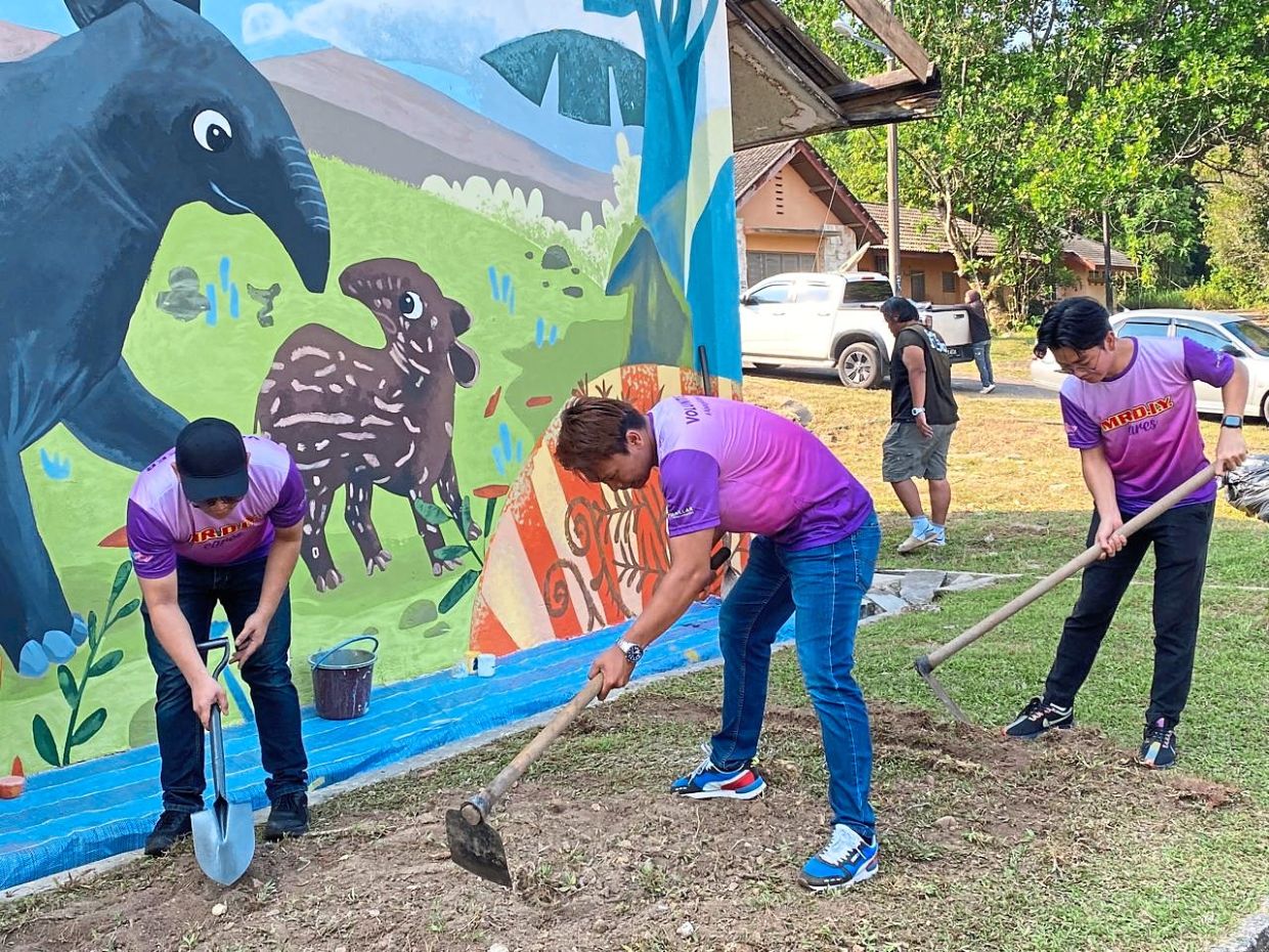 Volunteers painted the mural at Sungai Dusun Wildlife Conservation Centre and are seen here preparing the ground for planting.