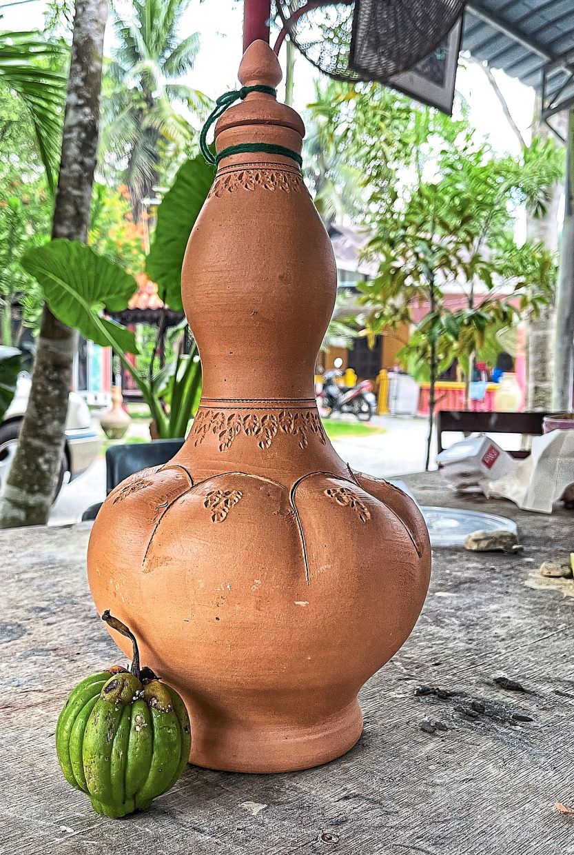 The traditional labu sayong, or gourd-shaped clay water jar, is a familiar sight in Kuala Kangsar. Photo: Shireen Zainudin