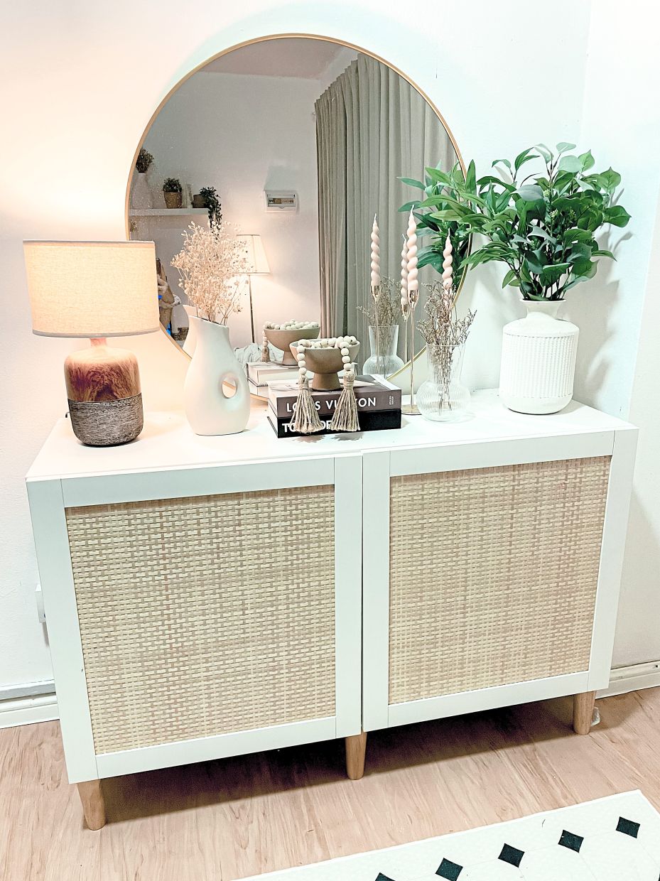 The white sideboard with woven poplar design works well as a storage space and display area.