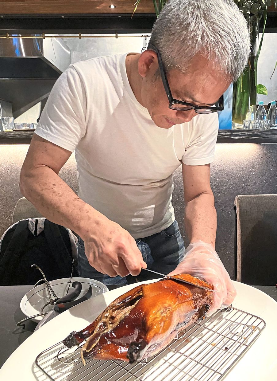 Ong carving the Crispy Duck.