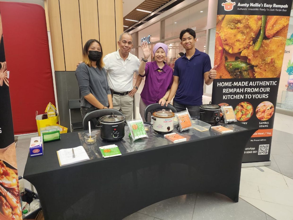 Nellie (second from right) promoting her pastes at a senior's event in Atria shopping mall recently. With her is (from left) her granddaughter Alisha, Amirul and grandson Adley.