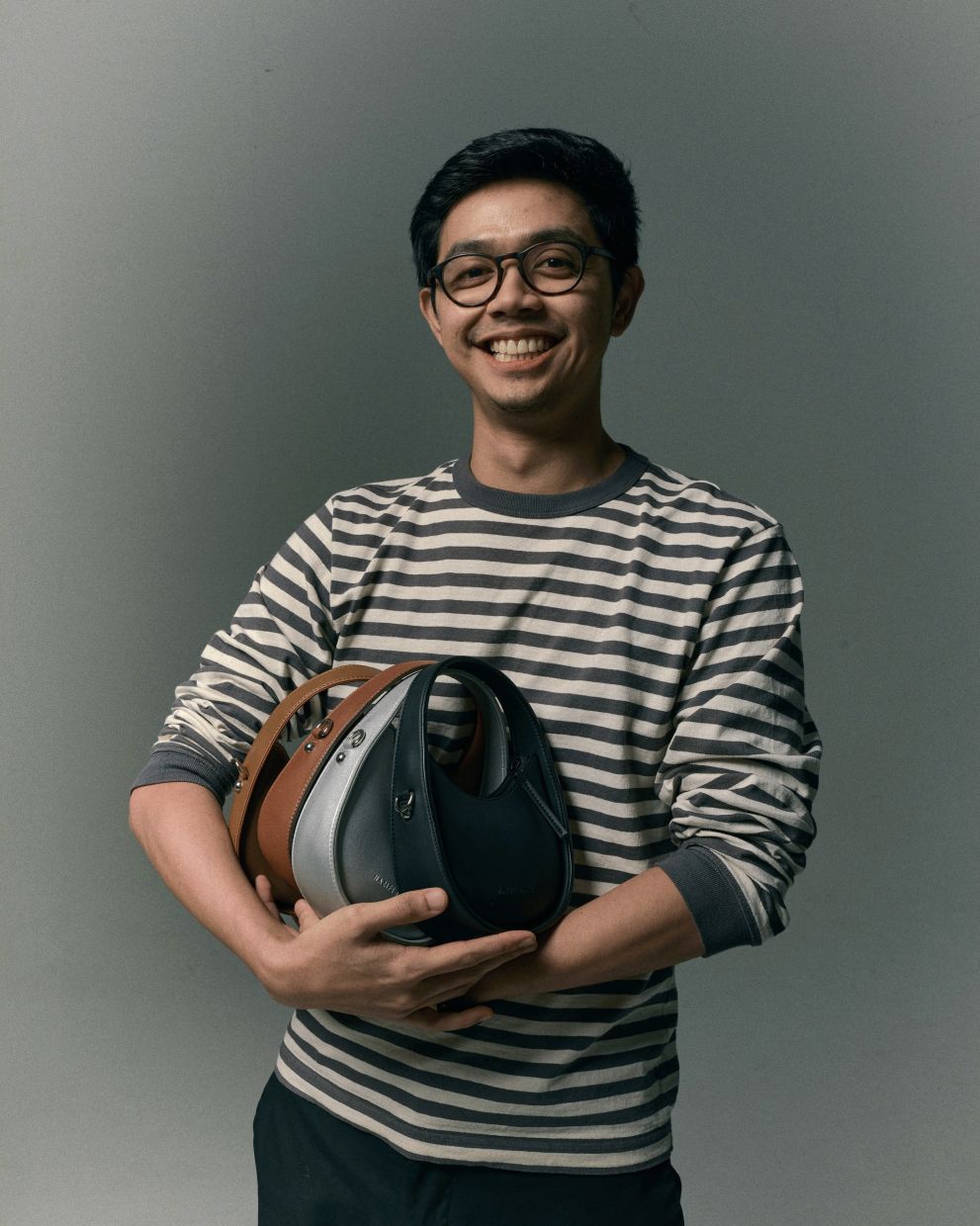 Nazifi Nazri started off designing sandals for men but his cute, colourful bags made his brand popular. — Photo: Nazifi Nasri